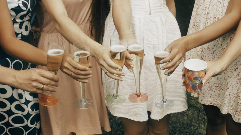 Party Goers Holding Champagne Glasses
